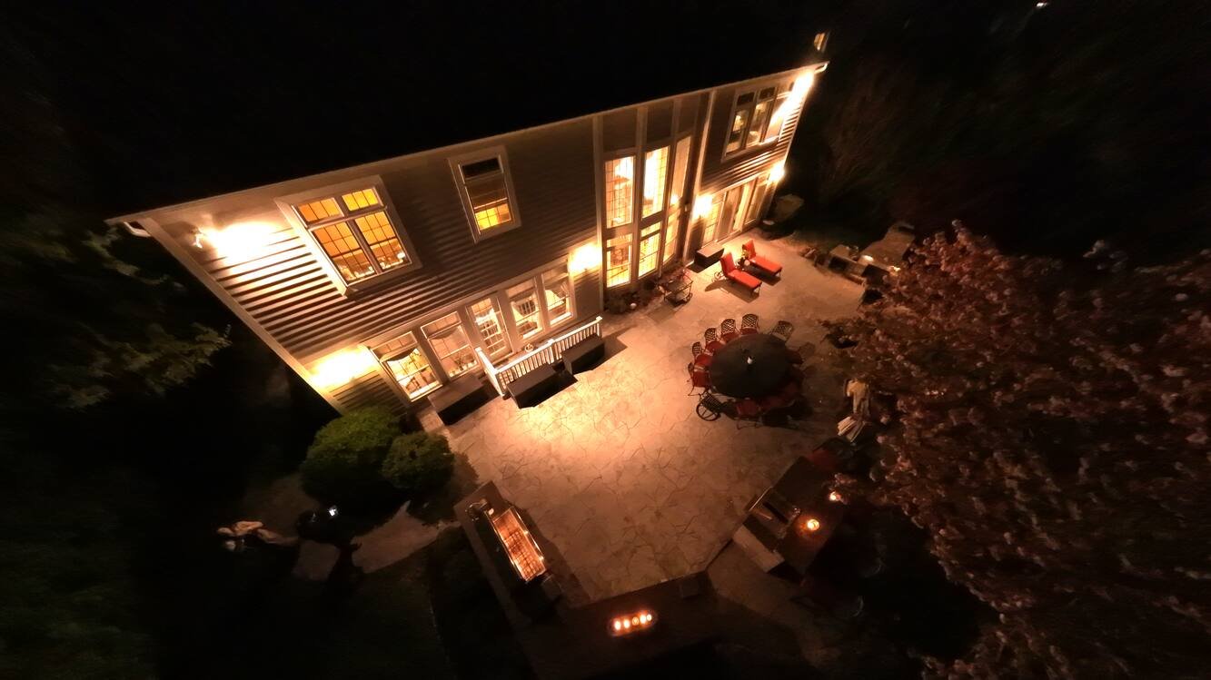 Elevated night view down onto the rear yard and pond frontage