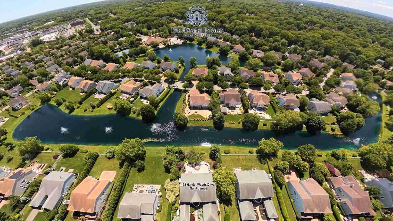 The community lake at Hamlet Estates in Saint James that 38 Hamlet Woods Drive fronts