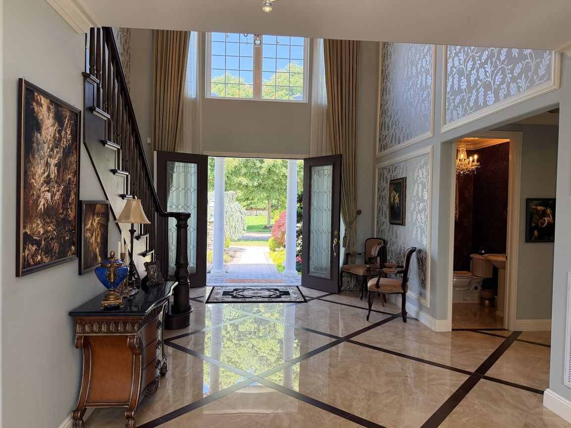 View from the dining area toward the two-story entry foyer and front doors