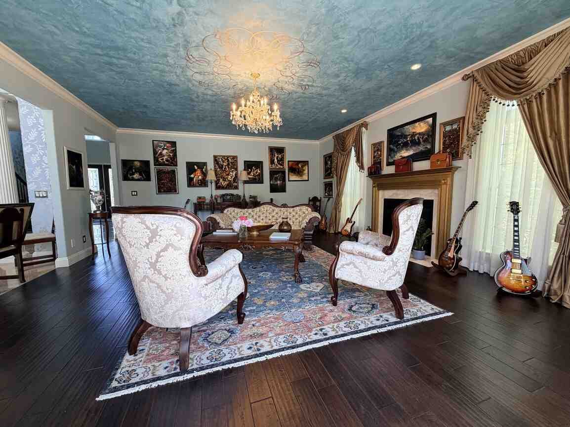 Gallery room with patio doors opening toward the rear terrace and pond