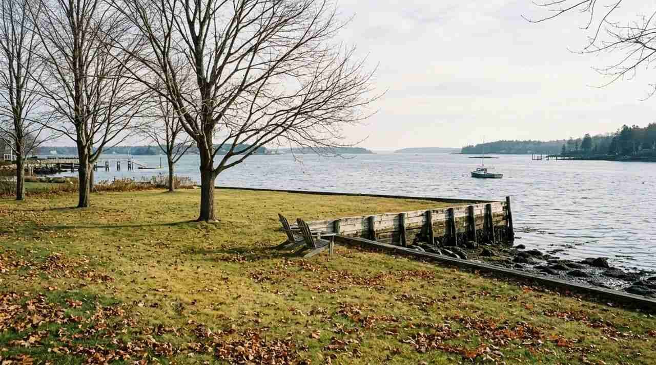 Waterfront lawn meeting a bulkhead above a tidal harbor on the Long Island Sound.